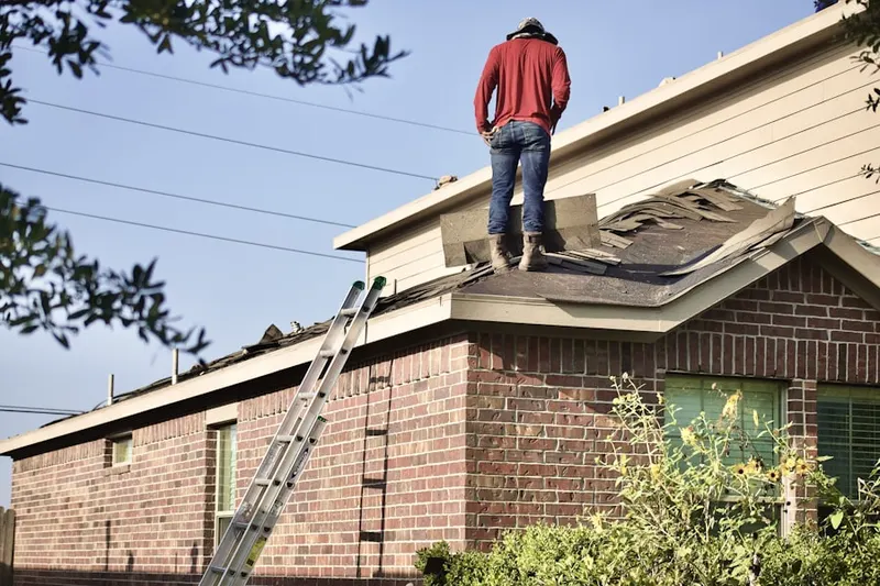 Professional roofer working on a residential roof in Waverly Woods